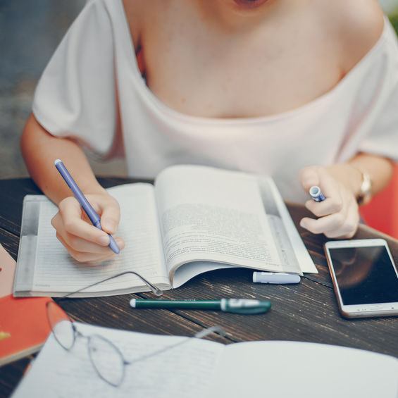 Photo of a woman writing in a notebook